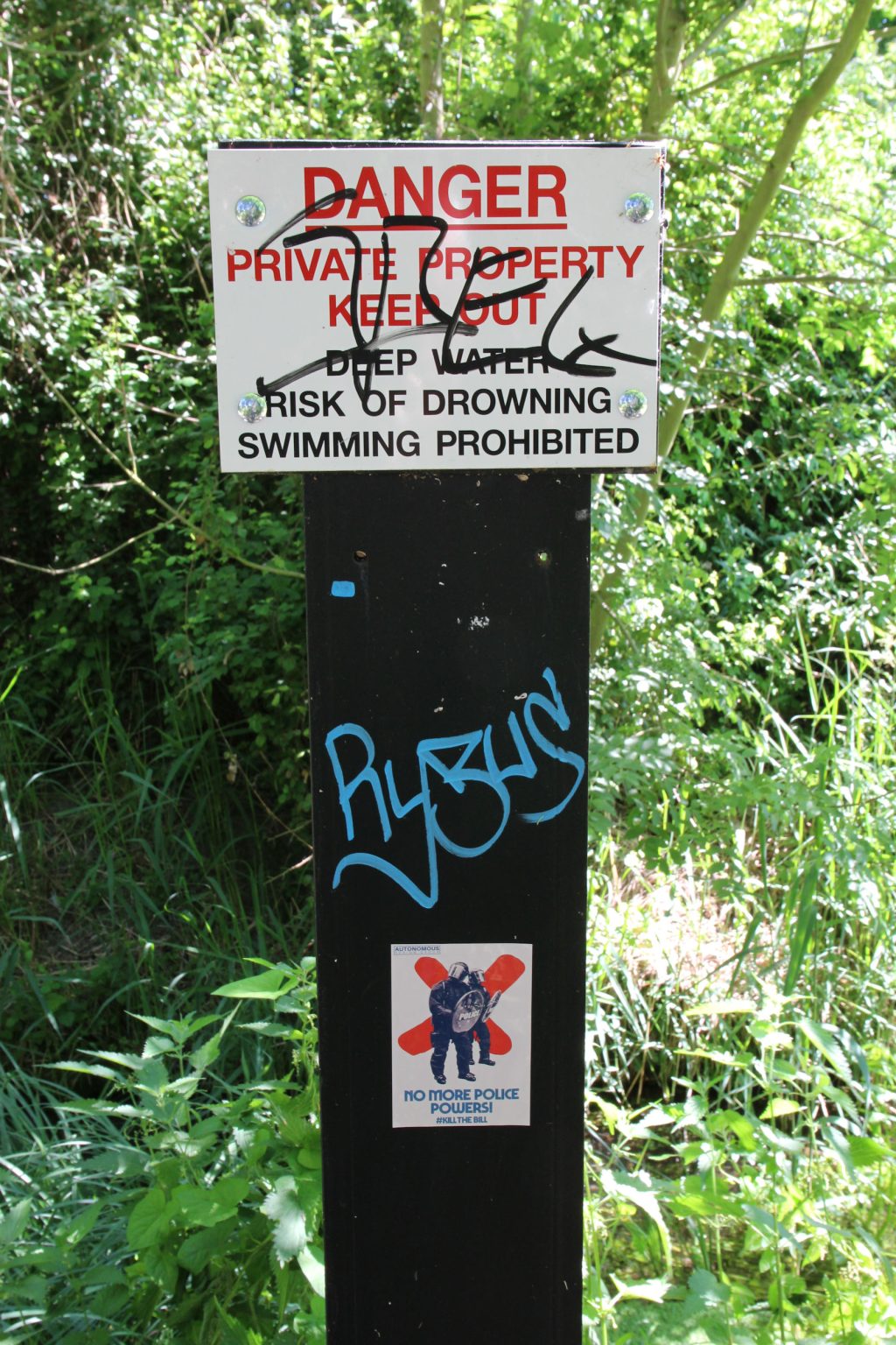 Defaced danger sign by Snakey Path