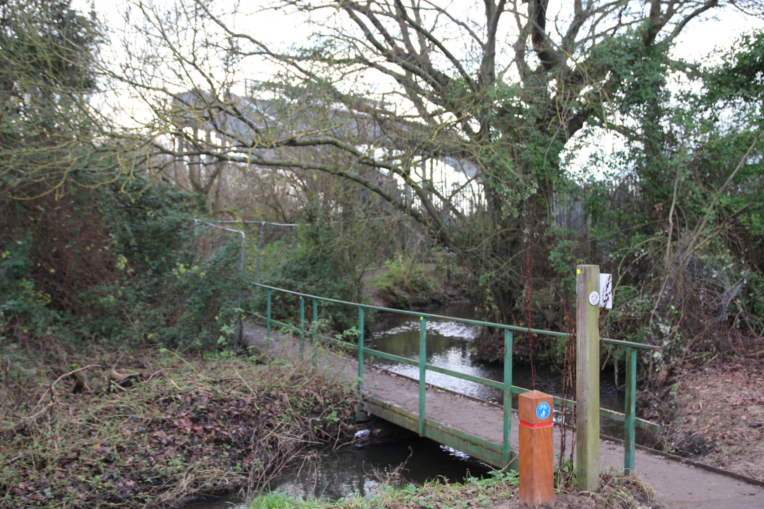 Bridge across Coldham's Brook to railway footbridge